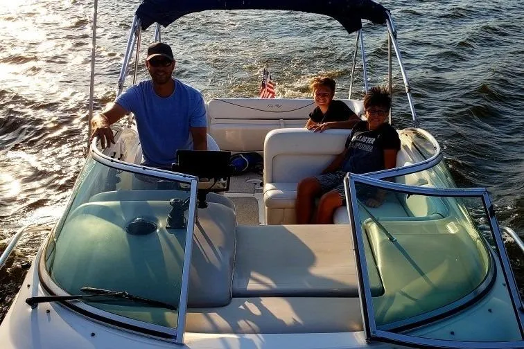 Slide: The Image of 2002 Sea Ray Sundancer 260 boat with three people enjoying a sunny day on the water. - 6