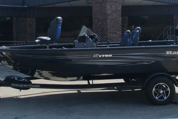 The Image of 2023 Ranger VS1782SC Angler boat on trailer, sleek design, parked outdoors. - 1