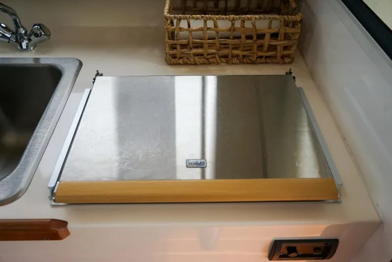 Slide: The Image of Stainless steel stove cover in 2018 C-Dory 25' Tomcat Catamaran kitchen area. - 12