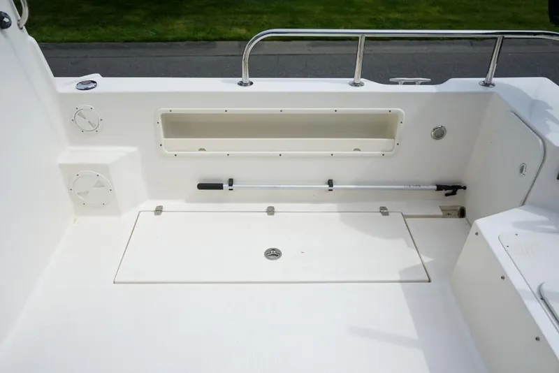 Slide: The Image of 2018 C-Dory 25' Tomcat Catamaran deck with storage compartment and railing. - 24