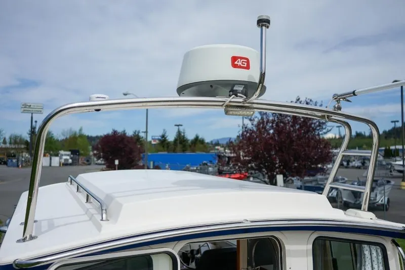 Slide: The Image of 2018 C-Dory 25' Tomcat Catamaran with 4G radar on roof, parked outdoors. - 7