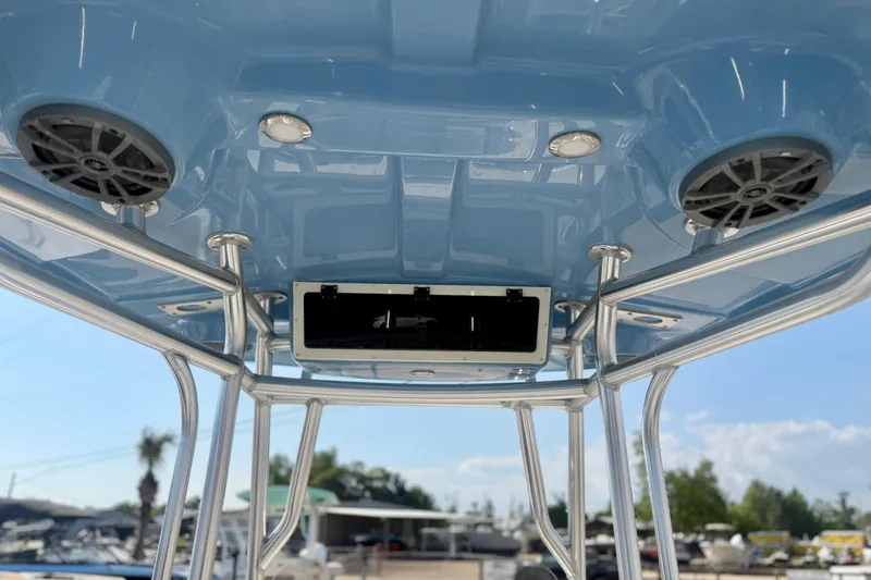 Slide: The Image of 2026 Carolina Skiff 22 Ultra Elite boat T-top with speakers and lights, blue sky background. - 17