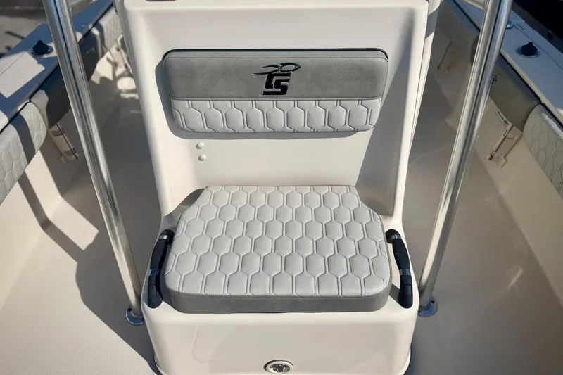 Slide: The Image of 2026 Carolina Skiff 22 Ultra Elite boat seat with hexagonal pattern and logo. - 21