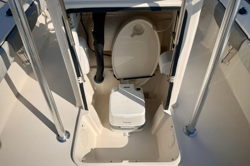 Slide: The Image of 2026 Carolina Skiff 22 Ultra Elite boat interior with portable toilet. - 22