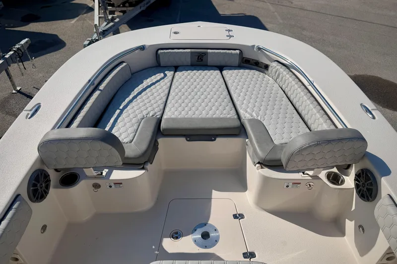Slide: The Image of 2026 Carolina Skiff 22 Ultra Elite boat with cushioned seating and stainless steel railings. - 23