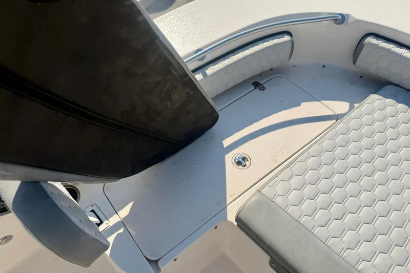 Slide: The Image of 2026 Carolina Skiff 22 Ultra Elite boat interior with cushioned seating and storage. - 26