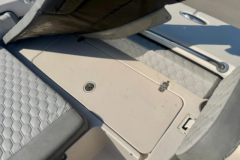 Slide: The Image of 2026 Carolina Skiff 22 Ultra Elite boat interior with hexagonal-patterned seating and storage compartment. - 27