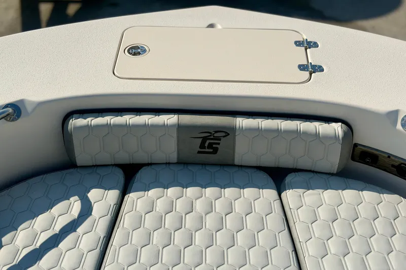 Slide: The Image of 2026 Carolina Skiff 22 Ultra Elite boat interior with hexagonal-patterned seating and storage compartment. - 29