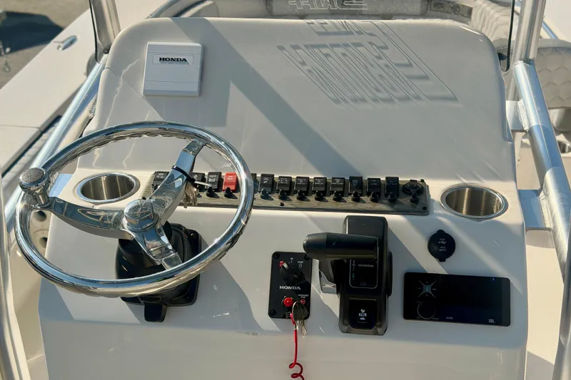 Slide: The Image of Steering console of 2026 Carolina Skiff 22 Ultra Elite with Honda controls and switches. - 3