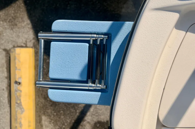 Slide: The Image of 2026 Carolina Skiff 22 Ultra Elite boat ladder, folded on textured deck surface. - 36
