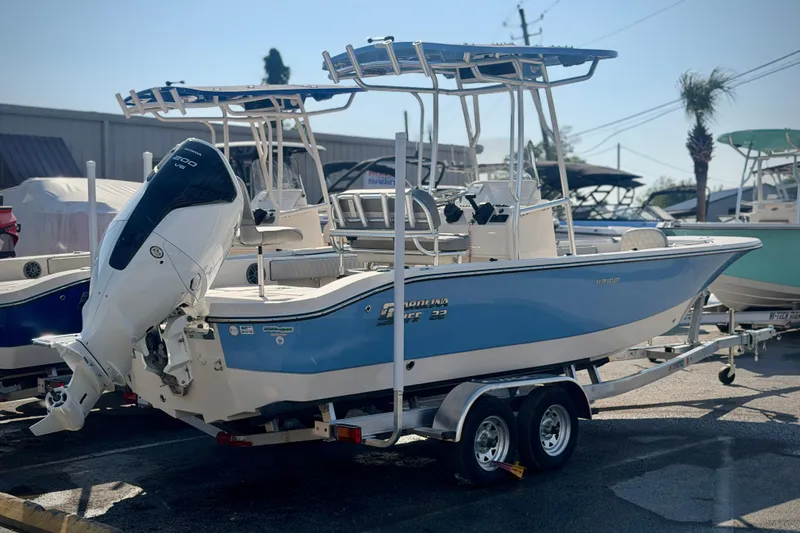 Slide: The Image of 2026 Carolina Skiff 22 Ultra Elite boat on trailer, featuring a powerful outboard motor. - 40