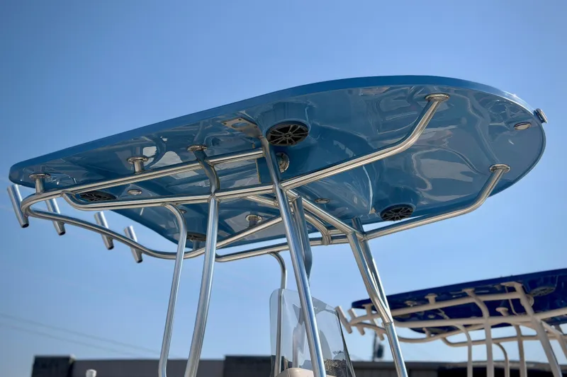 Slide: The Image of T-top of 2026 Carolina Skiff 22 Ultra Elite boat against clear blue sky. - 43