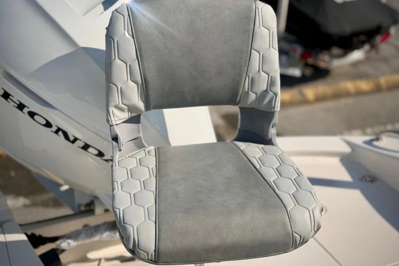 Slide: The Image of 2026 Carolina Skiff 22 Ultra Elite boat seat with hexagonal pattern and Honda engine. - 6