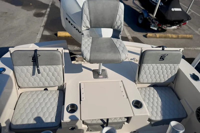 Slide: The Image of 2026 Carolina Skiff 22 Ultra Elite boat seating area with cushioned seats and table. - 8