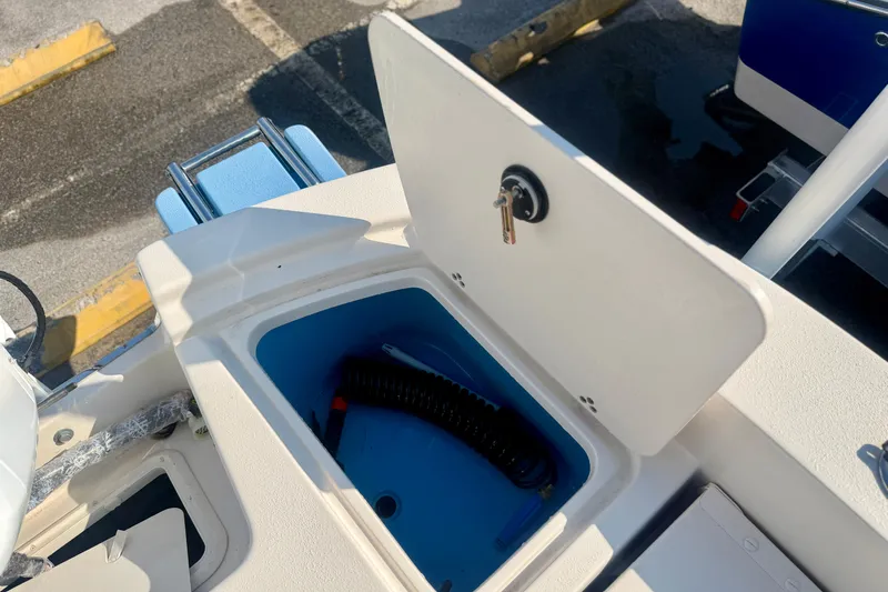 Slide: The Image of Storage compartment on a 2026 Carolina Skiff 22 Ultra Elite boat, featuring a key lock. - 9