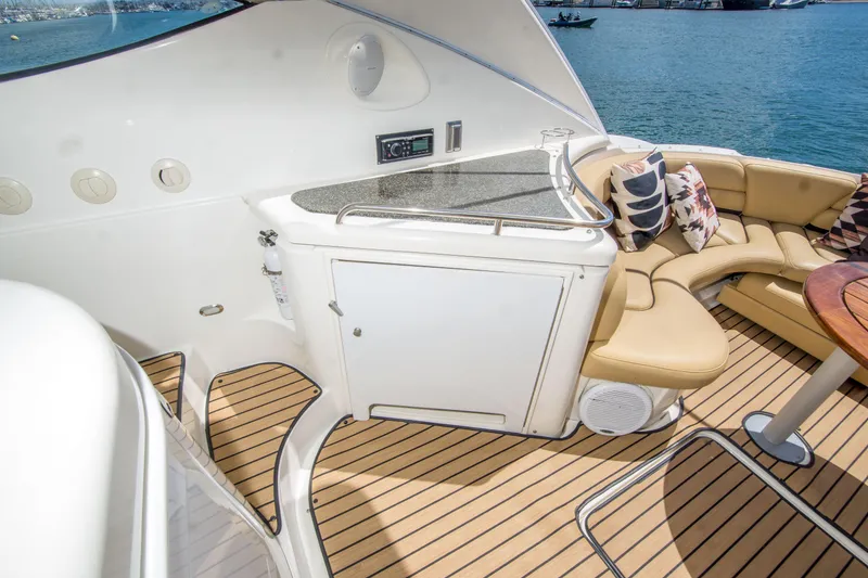 Slide: The Image of Luxurious 2005 Cruisers Yachts 540 Express interior with seating and kitchenette on deck. - 13