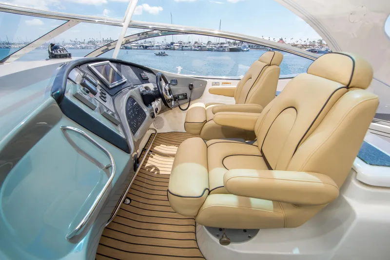 Slide: The Image of Luxurious 2005 Cruisers Yachts 540 Express helm with leather seats and modern controls. - 17