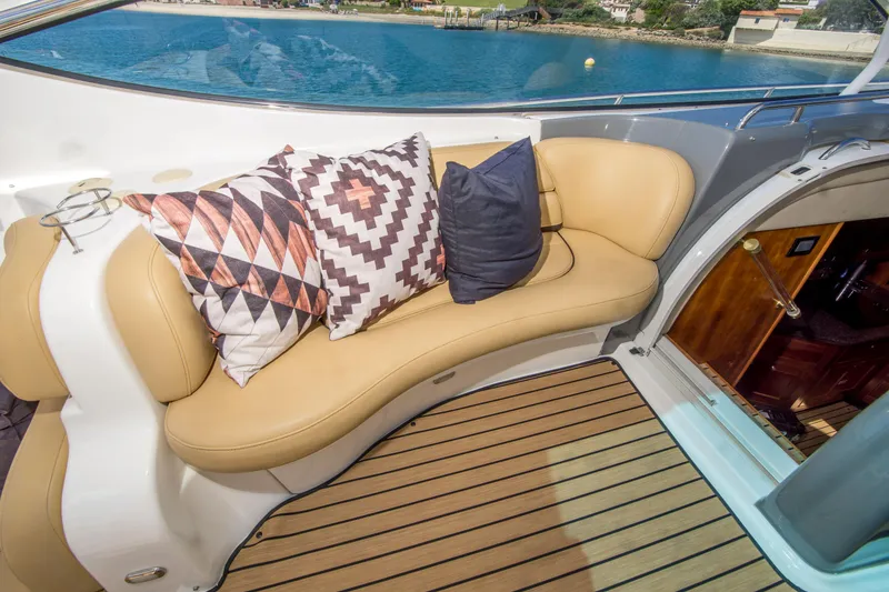 Slide: The Image of Luxurious seating area on 2005 Cruisers Yachts 540 Express with decorative pillows and teak flooring. - 18