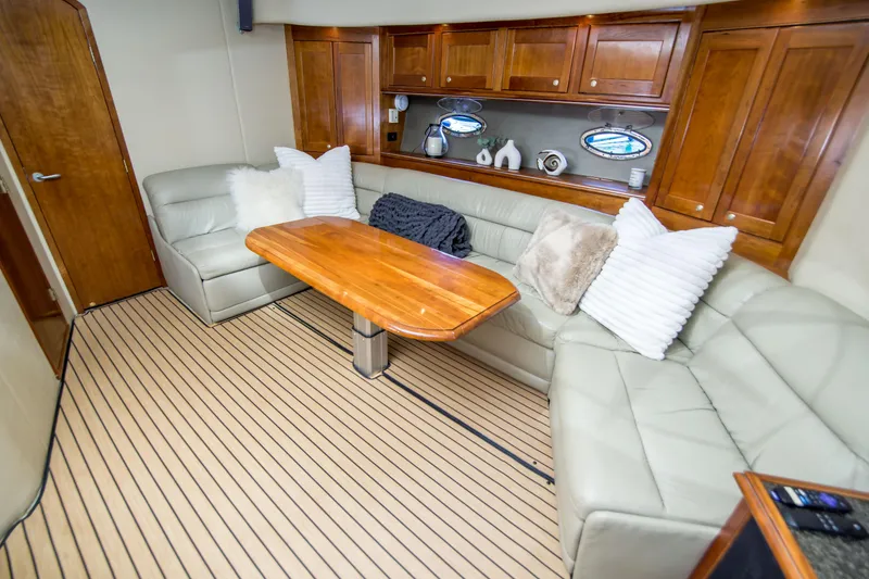 Slide: The Image of Luxurious 2005 Cruisers Yachts 540 Express interior with plush seating and elegant wood finishes. - 19