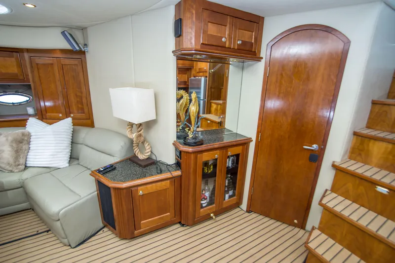 Slide: The Image of Luxurious interior of 2005 Cruisers Yachts 540 Express with elegant wood cabinetry and plush seating. - 23