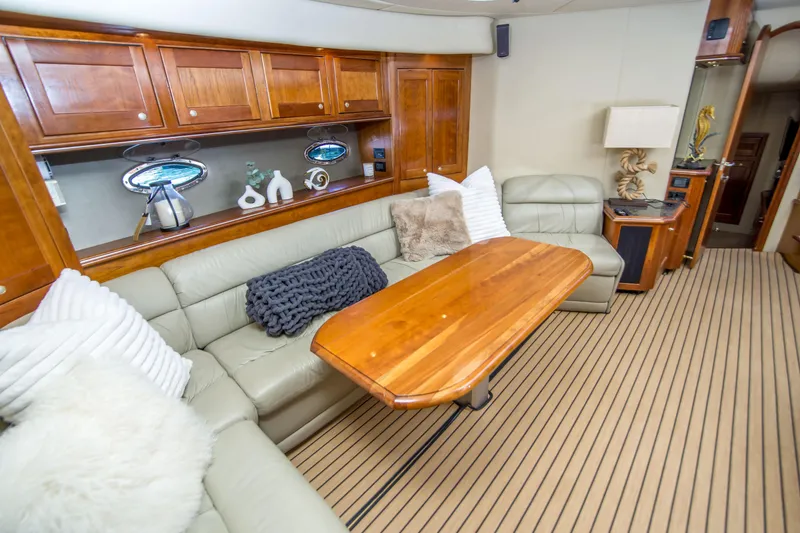 Slide: The Image of Luxurious interior of 2005 Cruisers Yachts 540 Express with plush seating and wooden table. - 24