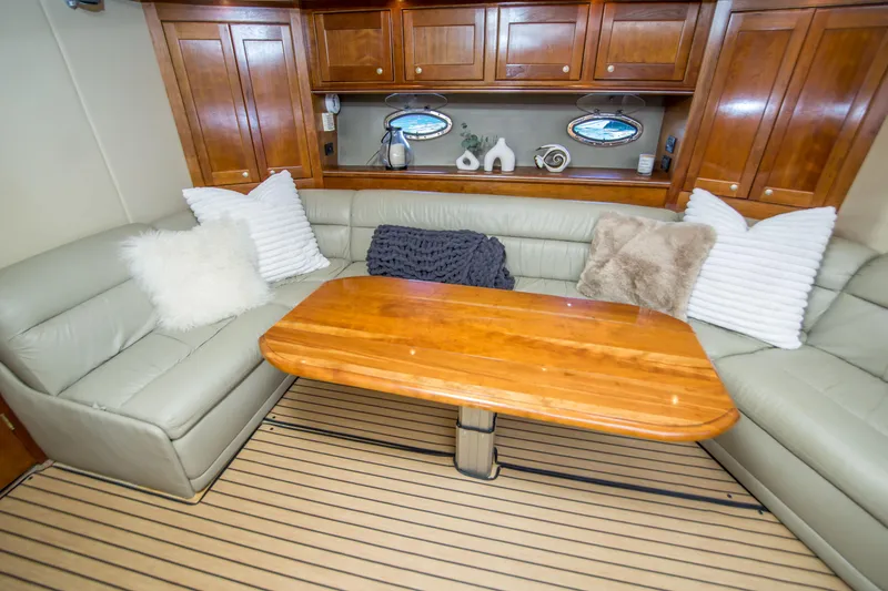 Slide: The Image of Luxurious interior of 2005 Cruisers Yachts 540 Express with plush seating and wooden table. - 25