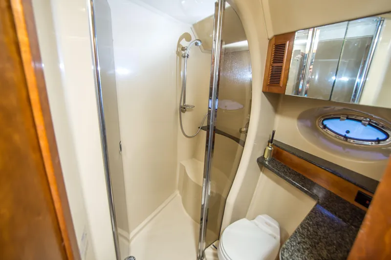 Slide: The Image of Luxurious bathroom in 2005 Cruisers Yachts 540 Express with shower and porthole window. - 27
