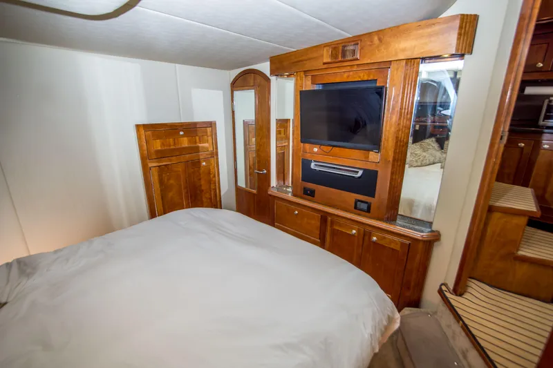 Slide: The Image of Luxurious cabin interior of 2005 Cruisers Yachts 540 Express with wood finishes and TV. - 29