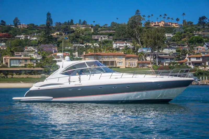 Slide: The Image of 2005 Cruisers Yachts 540 Express on water, scenic coastal backdrop. - 3
