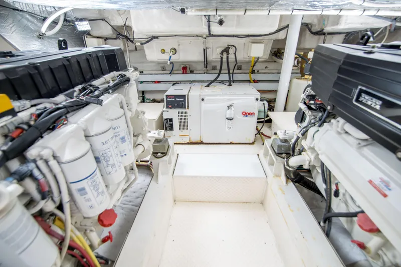 Slide: The Image of Engine room of 2005 Cruisers Yachts 540 Express with Onan generator and mechanical components. - 32