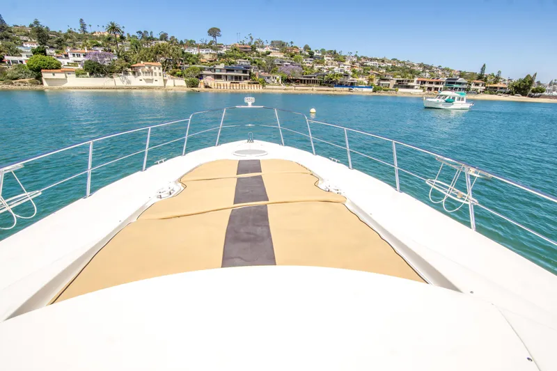 Slide: The Image of 2005 Cruisers Yachts 540 Express on serene water with coastal view. - 7