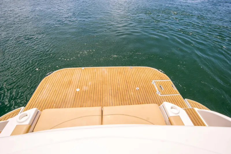 Slide: The Image of 2005 Cruisers Yachts 540 Express swim platform on calm water. - 8