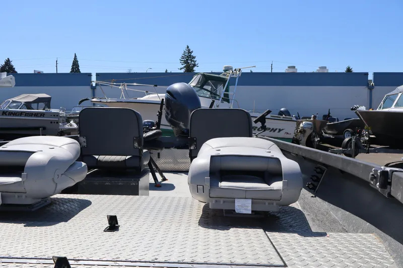 Slide: The Image of 2017 Alumaweld Super Vee LT 20 boat interior with seating and motor, in a marina setting. - 10