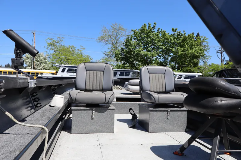 Slide: The Image of 2017 Alumaweld Super Vee LT 20 boat interior with two gray seats under clear blue sky. - 11