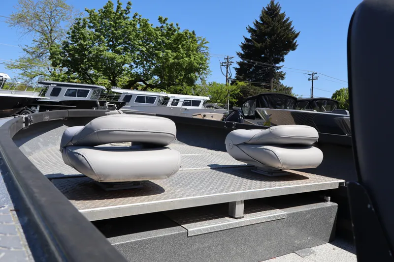 Slide: The Image of 2017 Alumaweld Super Vee LT 20 boat interior with two gray seats on a sunny day. - 8