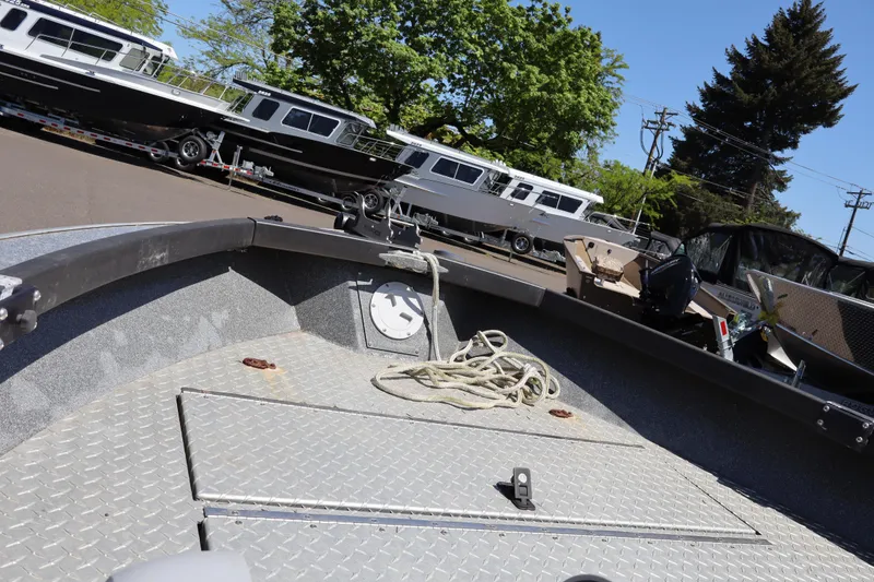 Slide: The Image of 2017 Alumaweld Super Vee LT 20 boat interior with rope, parked boats in background. - 9