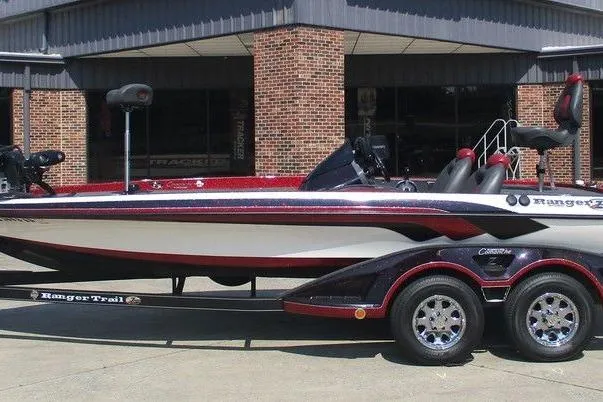 The Image of 2012 Ranger Z520 boat with trailer, parked outside a brick building. - 1