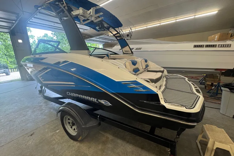 Slide: The Image of 2017 Chaparral Vortex 203 VRX boat in a garage, showcasing sleek design and vibrant colors. - 4