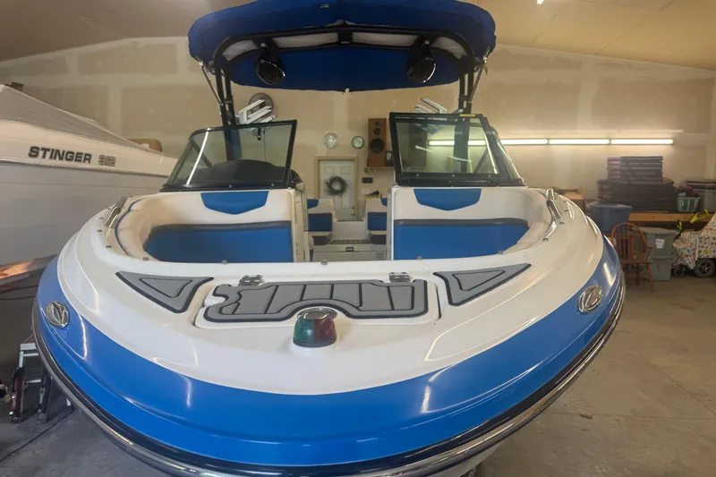 Slide: The Image of 2017 Chaparral Vortex 203 VRX boat in garage, blue and white design, front view. - 5