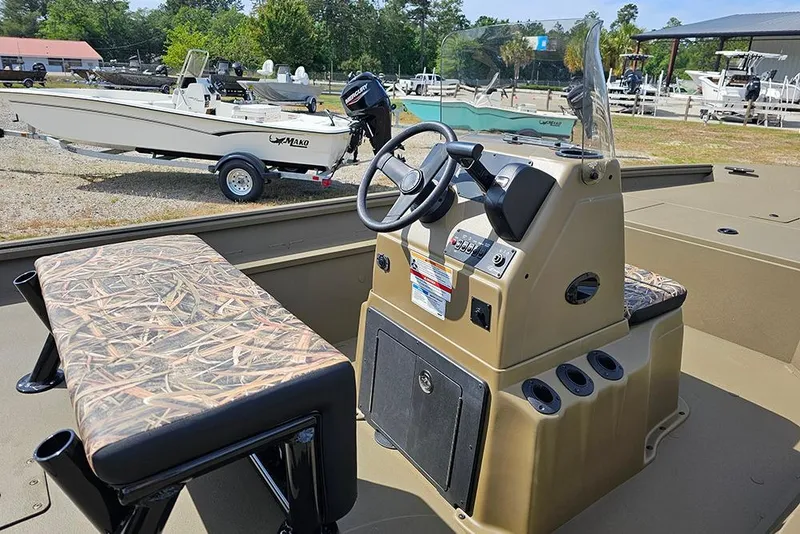 Slide: The Image of 2026 G3 Gator Tough 18 CC boat interior with camo seating and steering console. - 10