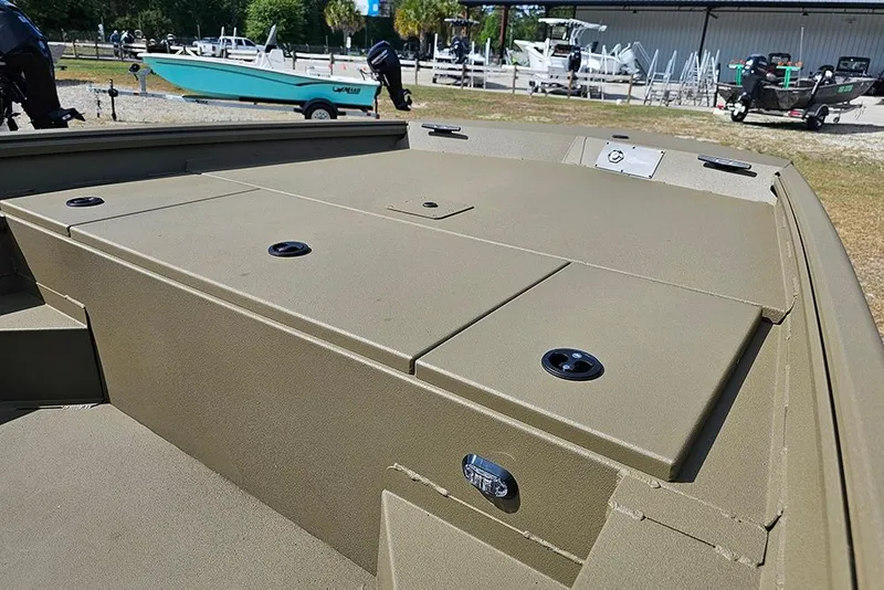 Slide: The Image of 2026 G3 Gator Tough 18 CC boat deck, featuring storage compartments and fishing rod holders. - 13
