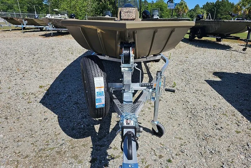 Slide: The Image of 2026 G3 Gator Tough 18 CC boat on trailer, parked on gravel lot. - 23
