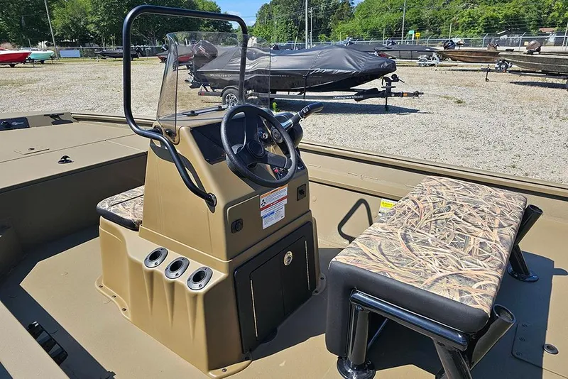 Slide: The Image of 2026 G3 Gator Tough 18 CC boat interior with camouflage seating and steering console. - 29