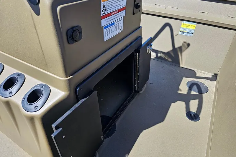 Slide: The Image of 2026 G3 Gator Tough 18 CC boat interior with open storage compartment and rod holders. - 30
