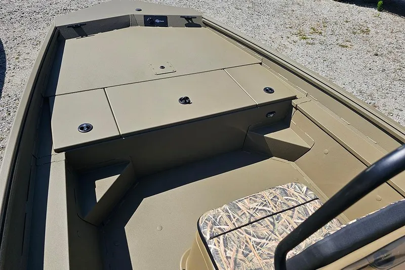 Slide: The Image of 2026 G3 Gator Tough 18 CC boat interior with storage compartments and camo seat. - 33