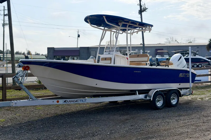 Slide: The Image of 2026 Carolina Skiff 24 Ultra Elite boat on trailer, parked outdoors. - 1