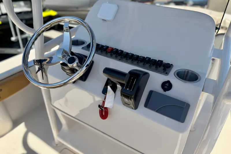 Slide: The Image of 2026 Carolina Skiff 24 Ultra Elite boat console with steering wheel and controls. - 10