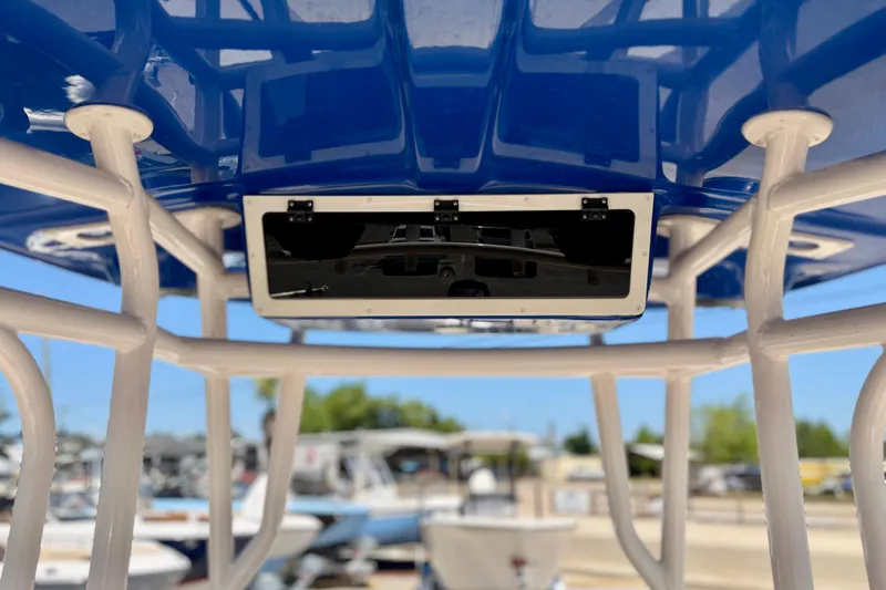 The Image of 2026 Carolina Skiff 24 Ultra Elite T-top structure with blue canopy and mounted equipment. - 11
