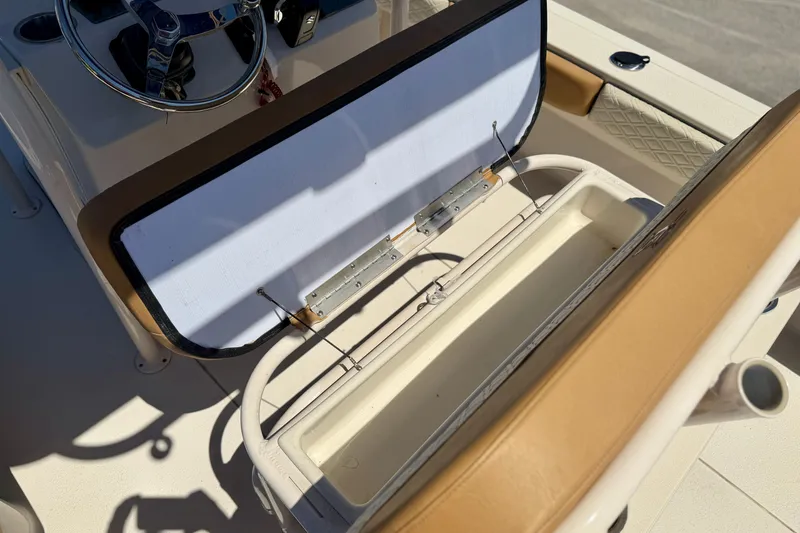 Slide: The Image of 2026 Carolina Skiff 24 Ultra Elite boat interior with open storage compartment. - 14