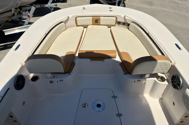 Slide: The Image of 2026 Carolina Skiff 24 Ultra Elite boat interior with cushioned seating and storage compartments. - 16